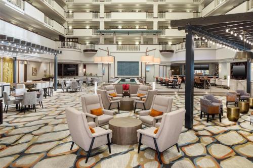 a lobby of a hotel with chairs and tables at Embassy Suites by Hilton Laredo in Laredo