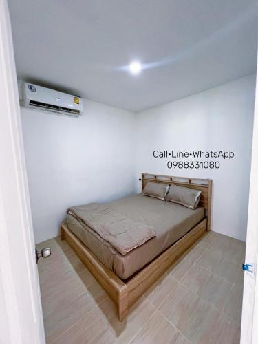 a bedroom with a bed in a white room at Tim House Thalang 3 in Ban Phak Chit