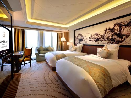 a hotel room with two beds and a television at RenHe Spring Hotel in Chengdu