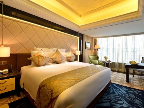 a hotel room with a large bed and a desk at RenHe Spring Hotel in Chengdu