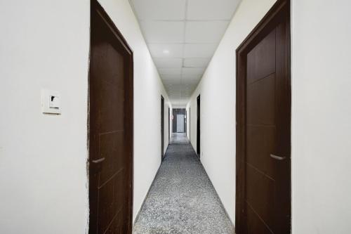 a corridor of an office with two doors at Super Collection O Atlas DLF Formerly Hillside in Kondapur
