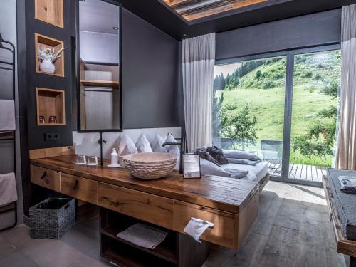 a bathroom with a wooden table and a large window at KRAFTalm in Itter