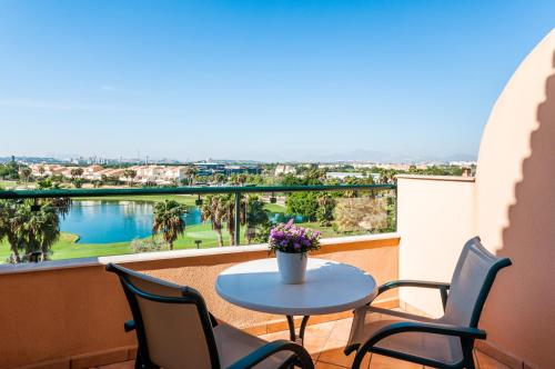 a balcony with a table and chairs and a view at Hotel Alicante Golf in Alicante