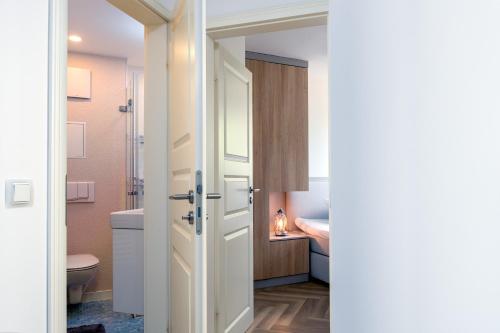 a bathroom with a toilet and a sink at FeWo Dwarslöper in Sassnitz