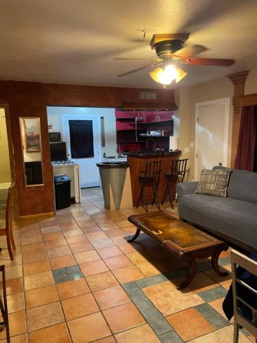 a living room with a couch and a table at THE SINATRA STUDIO FULL KITCHEN and SWIMMING POOL walk to ARTS RooSEVELT ROW CONVENTION CENTER ASU DOWNTOWN PHOENIX in Phoenix