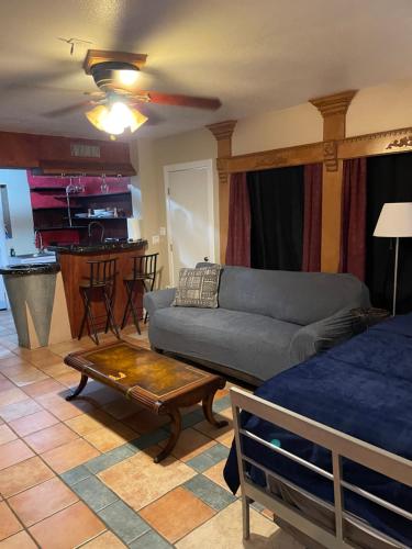 a living room with a couch and a table at THE SINATRA STUDIO FULL KITCHEN and SWIMMING POOL walk to ARTS RooSEVELT ROW CONVENTION CENTER ASU DOWNTOWN PHOENIX in Phoenix
