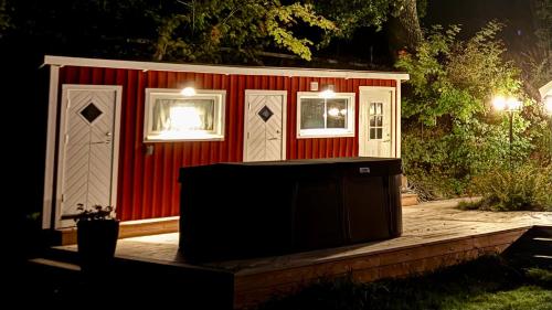 a red shed with a tv in front of it at Solvik Lakehouse & Outdoor Spa in Vreta Kloster