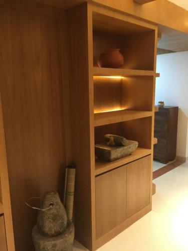 a book shelf with two stuffed animals in a room at Premium ,modern 2 rooms apartment in Thiruvalla