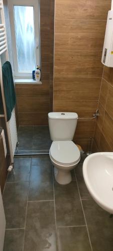 a bathroom with a white toilet and a sink at Yellow in Miltenberg