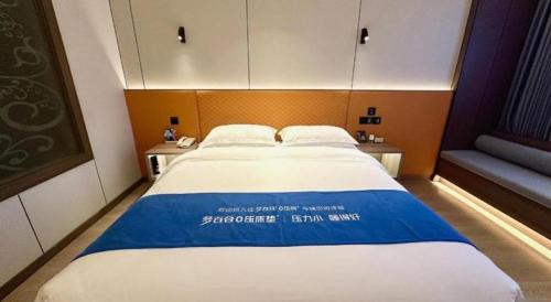 a large bed in a small room with two tables at Chengdu Haotian Guotai Hotel in Chengdu