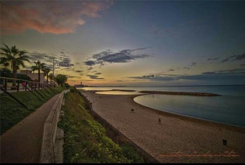 a beach with people on the sand and the ocean at Apulia '800 in San Pietro Vernotico