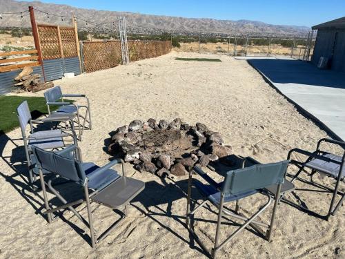 two chairs and a fire pit in a yard at Ranch Property on 2 acres! in Desert Hot Springs
