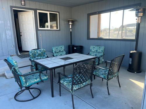 a table and some chairs and a table and a table and chairs at Ranch Property on 2 acres! in Desert Hot Springs