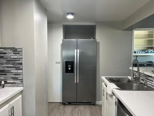 a stainless steel refrigerator in a white kitchen at Ranch Property on 2 acres! in Desert Hot Springs