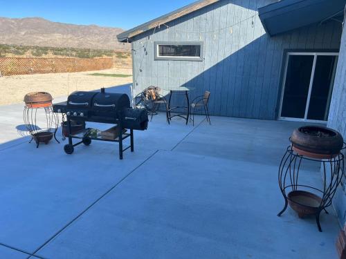 a patio with a grill and a table and chairs at Ranch Property on 2 acres! in Desert Hot Springs