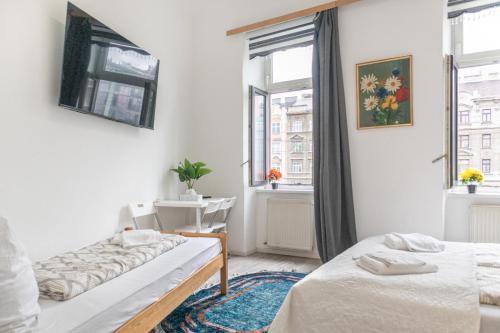 a bedroom with two beds and a window at Budget 1BR Studio near Danube & Millenium Tower in Vienna