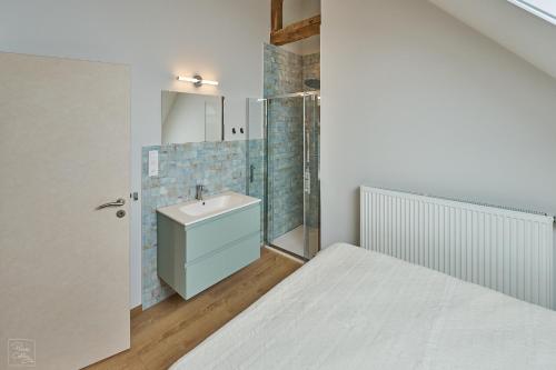 a bathroom with a bed and a sink at Les Campanes - Gite 8 personnes avec piscine intérieure et sauna 