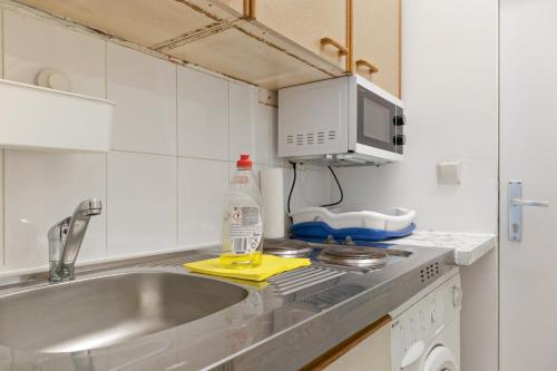a kitchen with a sink and a counter top at Budget 1BR Studio near Danube & Millenium Tower in Vienna