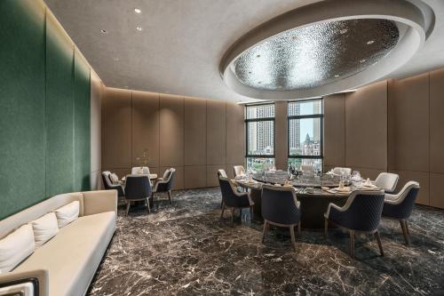 a dining room with a table and chairs at Novotel Kunshan East in Kunshan