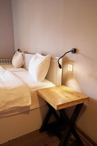 a room with a bed and a desk with a lamp at Pana Unique Kolsay in Kurmenty