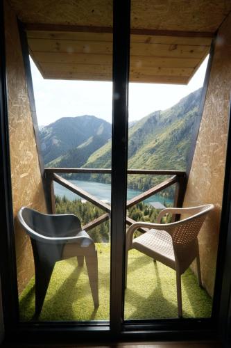 a room with a window with a chair and a view at Pana Unique Kolsay in Kurmenty