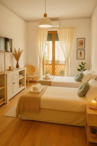 a bedroom with two beds and a window at Flaminio Luxury Home - City Center in Rome