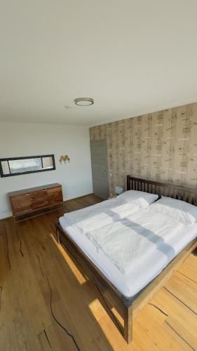 a bedroom with a large bed in a room at das Haus in Jois in Jois