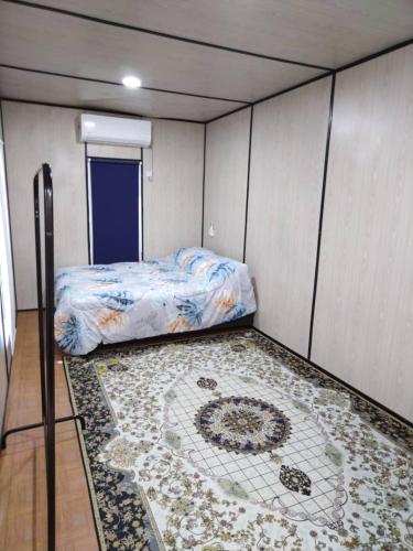 a small room with a bed and a rug at Bekbek's Village in Kangar