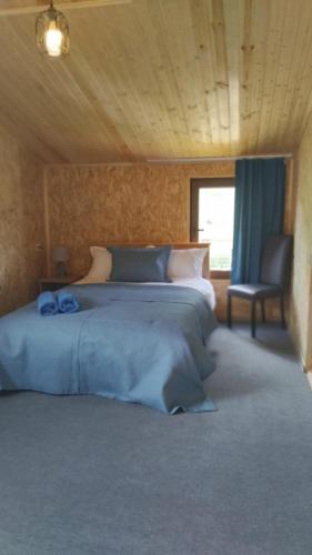 a bedroom with two beds and a chair and a window at Ushguli Terrace in Ushguli