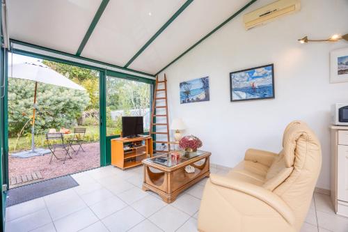 a living room with a couch and a tv at Gîte Du Peintre in Challans