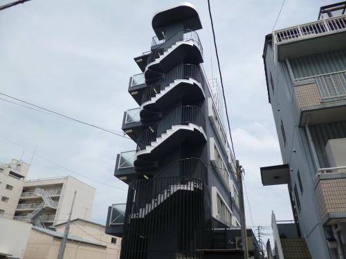 a black building with balconies on the side of it at OUCHI HOTEL Yokogawa in Hiroshima