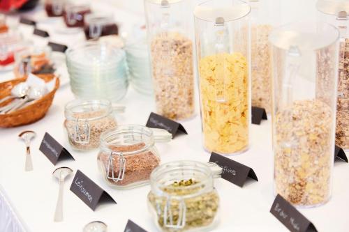 a table with jars of oatmeal and other food items at Vital Hotel an der Therme GmbH in Bad Windsheim