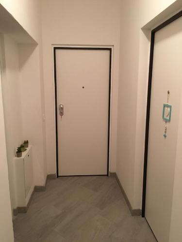 an empty hallway with a white door in a room at B&B and Apartments Armando Diaz in Trento