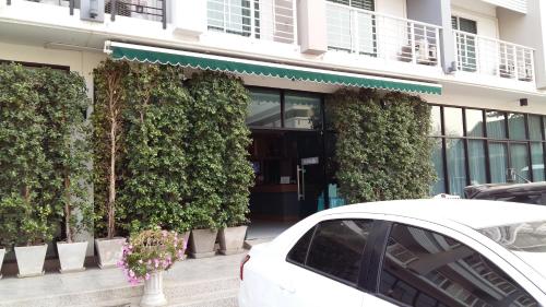 a white car parked in front of a building at U Place Korat in Nakhon Ratchasima