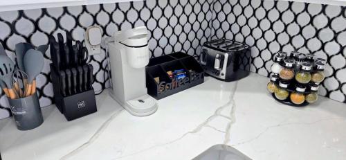a kitchen counter with utensils and a knife block at Newly Renovated 2B 2BA apt! mins to PATH & NY! in Jersey City