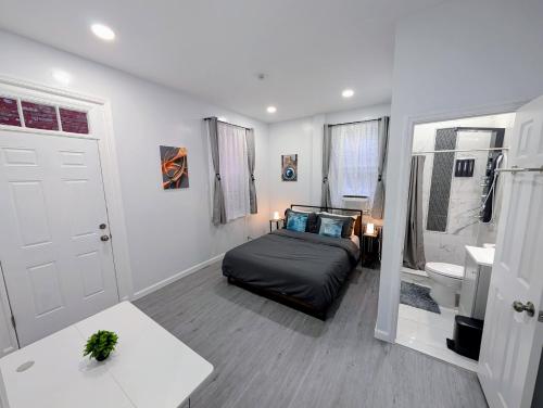 a bedroom with a bed and a sink and a toilet at Newly Renovated 2B 2BA apt! mins to PATH & NY! in Jersey City