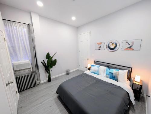 a bedroom with a large bed and a window at Newly Renovated 2B 2BA apt! mins to PATH & NY! in Jersey City