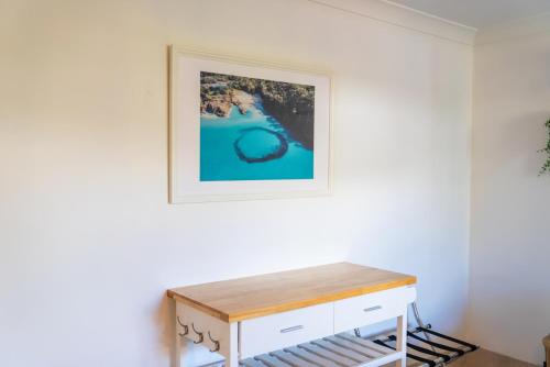 a room with a table and a picture on the wall at Studio 9 in Point Lookout