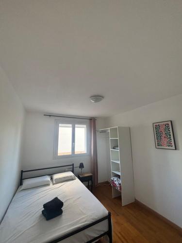 a bedroom with a bed with a black bag on it at Appartement T3 in Roanne