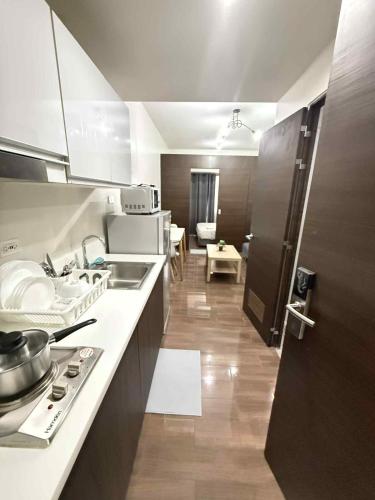 a kitchen with a sink and a counter top at Makati One Bed Room with Balcony Air Residence SMDC in Sampong