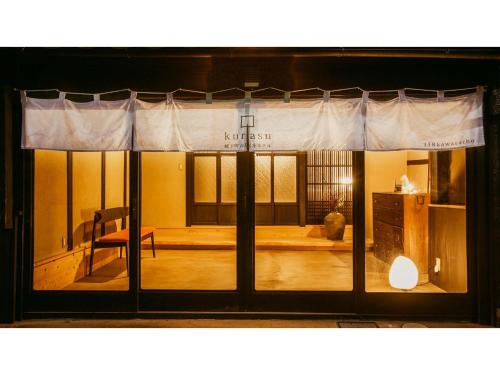a room with a window with a chair in it at Kominka Hotel kurasu - Vacation STAY 24260v in Tatsuno