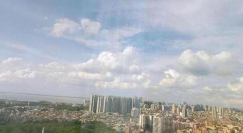 a view of a large city with buildings at Echarm Hotel Beihai Railway Station in Beihai
