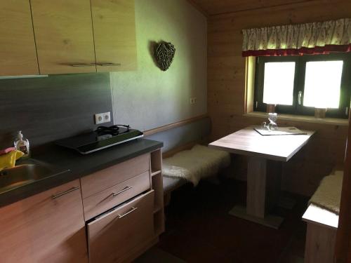 a kitchen with a counter and a sink and a table at Appartement Sonnenspitze 5 in Ehrwald