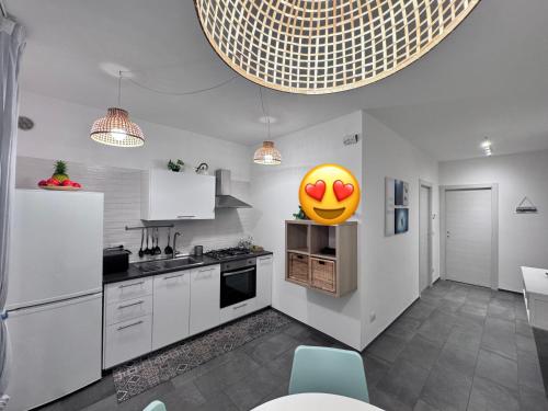 a kitchen with a yellow smiley face balloon on the wall at Casa Giorgia Monopoli in Monopoli