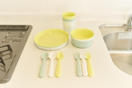 a table with utensils and bowls and a sink at 25 min to Shibuya by Train 1 min to Sta 86 square meters in Kugayama