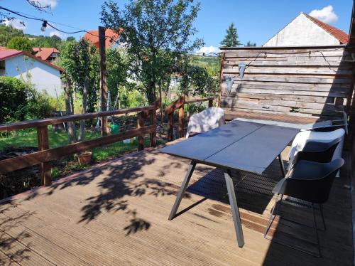 a blue table and chairs on a wooden deck at Pension Alte Schmiede in Treffurt