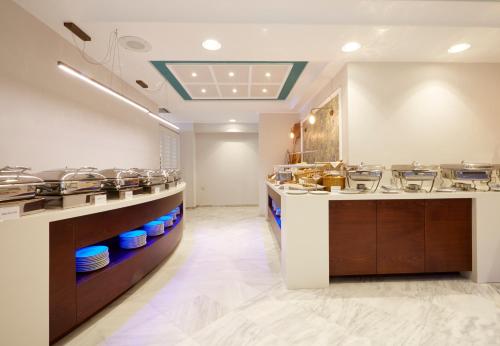 a large kitchen with many dishes on display at Volcano View by Caldera Collection in Fira