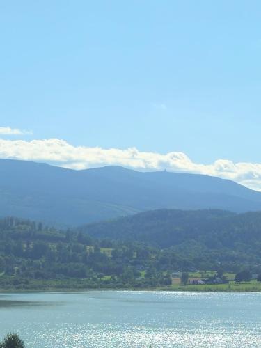 a large body of water with mountains in the background at Lake Mountain 5618 koło Karpacza in Sosnówka
