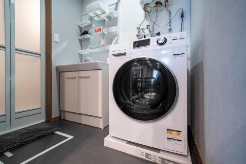 a washer and dryer in a laundry room at Mks 101 in Wada