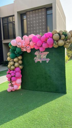 a display of pink and green balloons in front of a building at Nameer bay in Bandar Jişşah